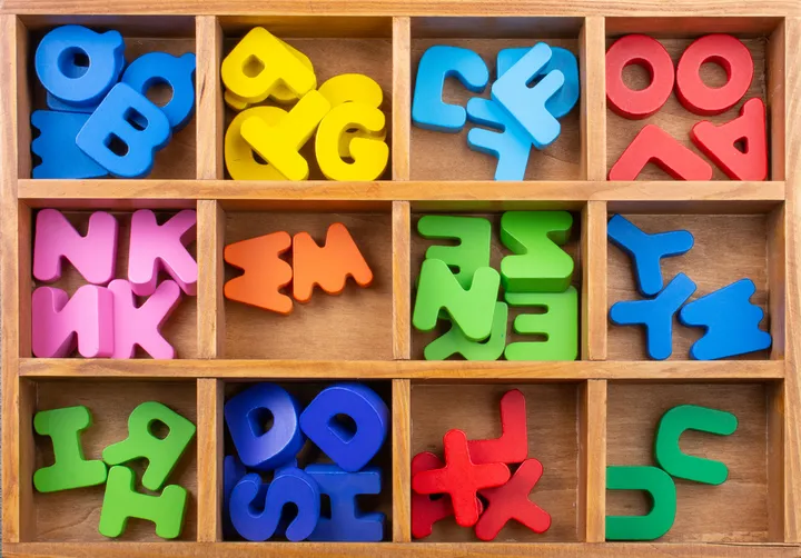 Colourful alphabet letters in a sorting tray